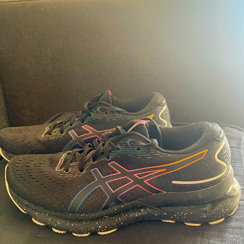 ASICS Gel Nimbus 24 black with iridescent rainbow trim.
